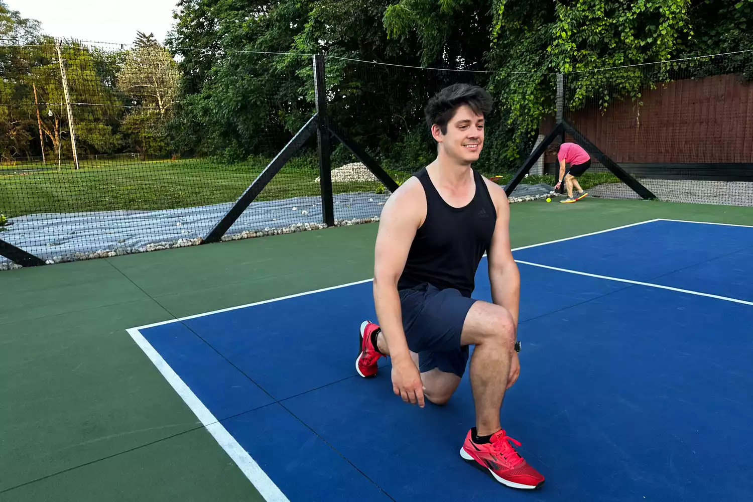 A person does lunges while wearing the Reebok Unisex Nano X4 Training Shoes