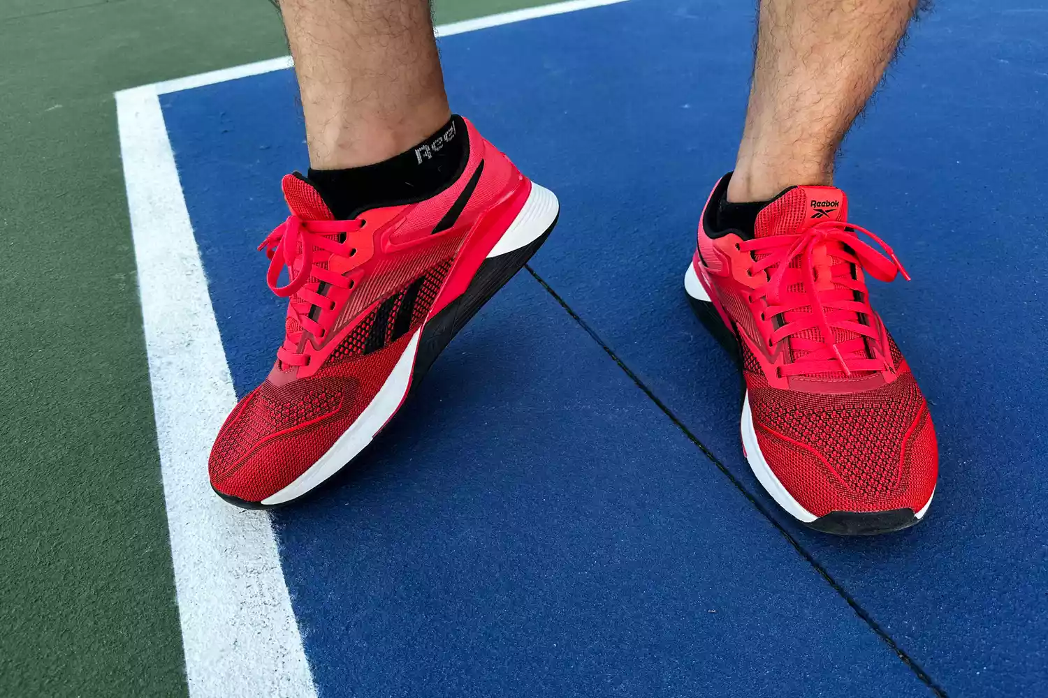 A front view of a person wearing the Reebok Unisex Nano X4 Training Shoes