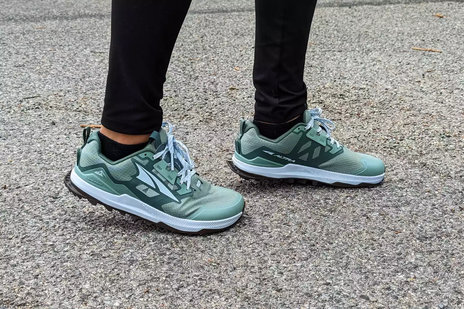 A close-up of a person posing in the Altra Lone Peak 8 Trail Running Shoes