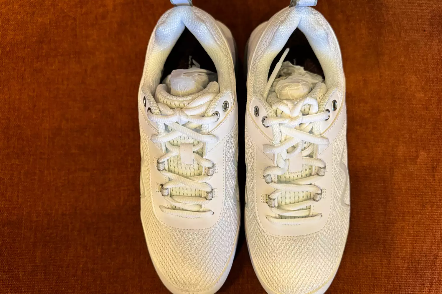 The top view of the MBT Women's Sport 4 II shoes on a brown background