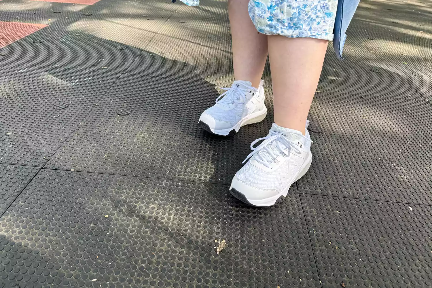 A person wearing MBT Women&acirc;s Sport 4 II on a black textured background