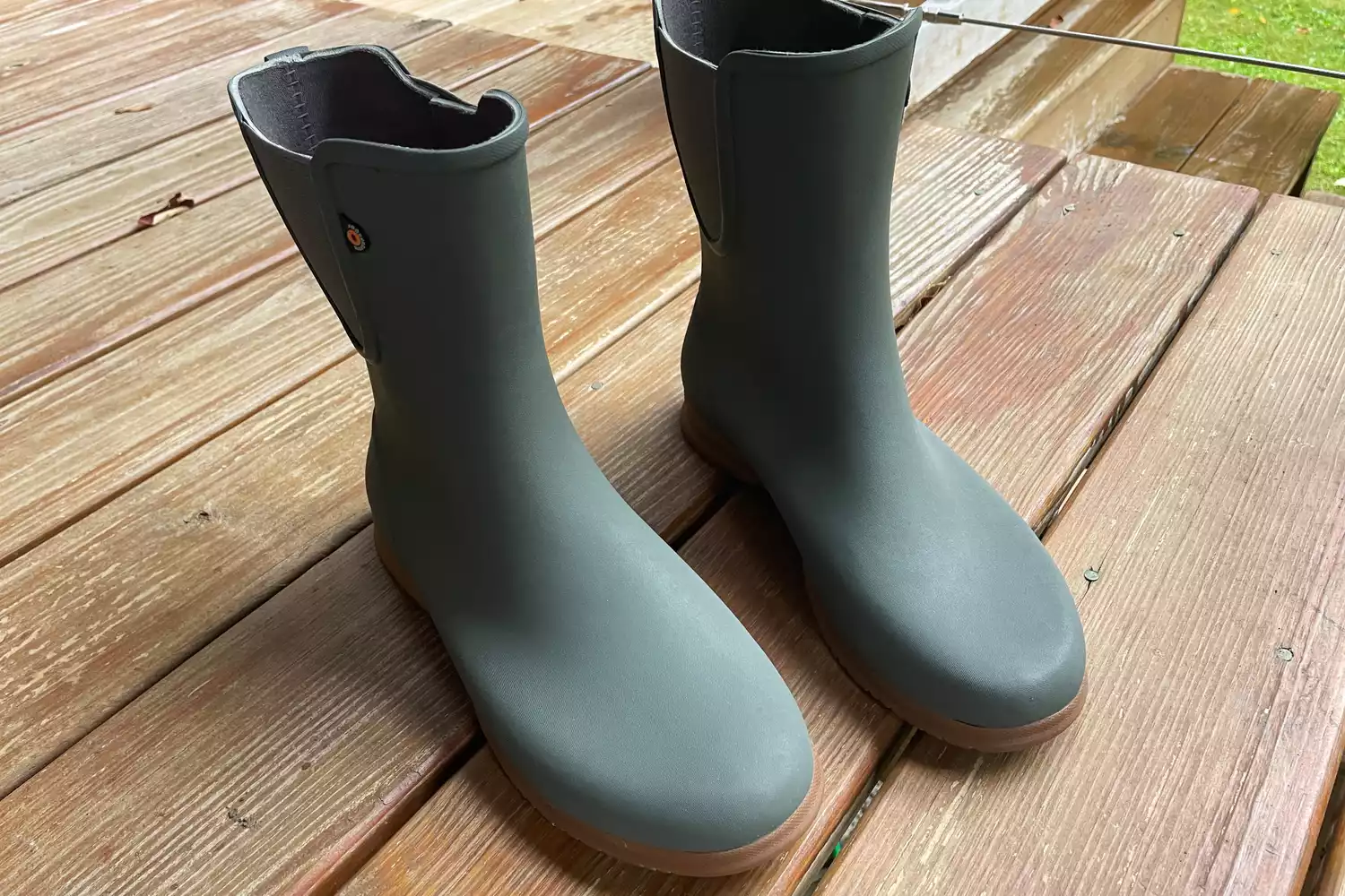 Bogs Women's Sweetpea Tall Rain Boots on a wooden deck