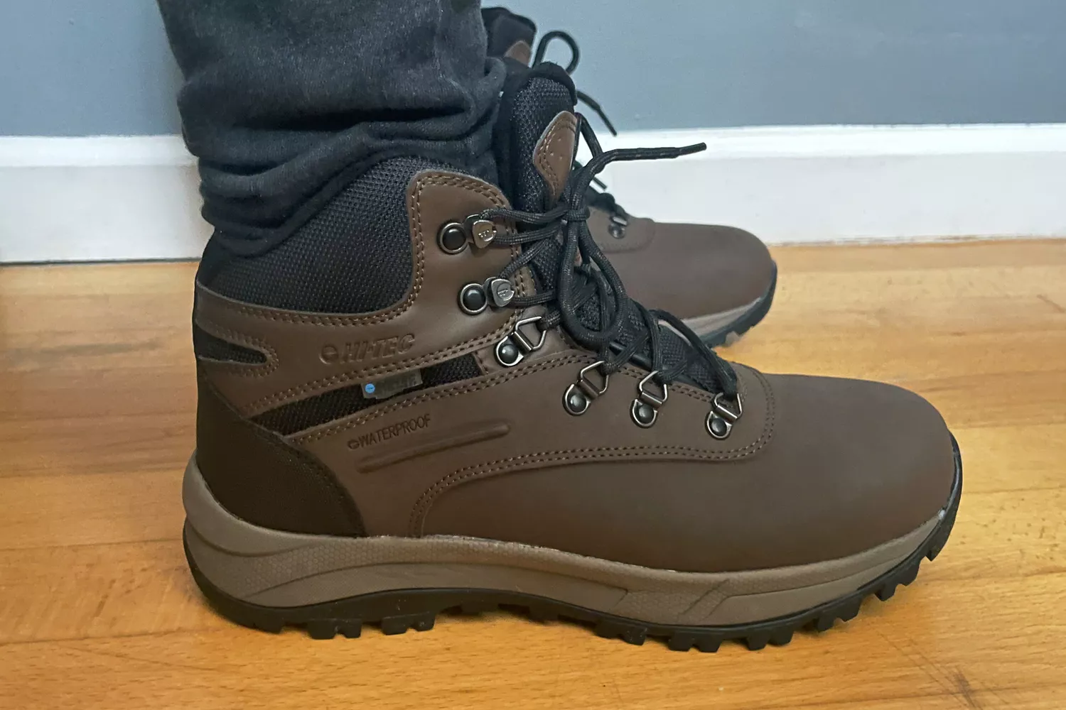 A person standing on a wood floor in the Hi-Tec Women's Altitude VI I WP Hiking Boots