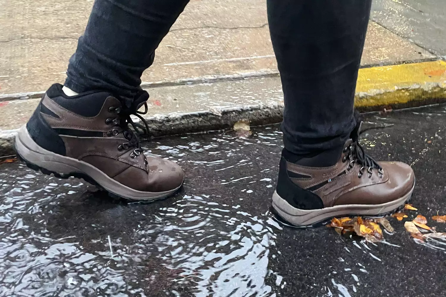 A person walks in water while wearing the Hi-Tec Women's Altitude VI I WP Hiking Boots