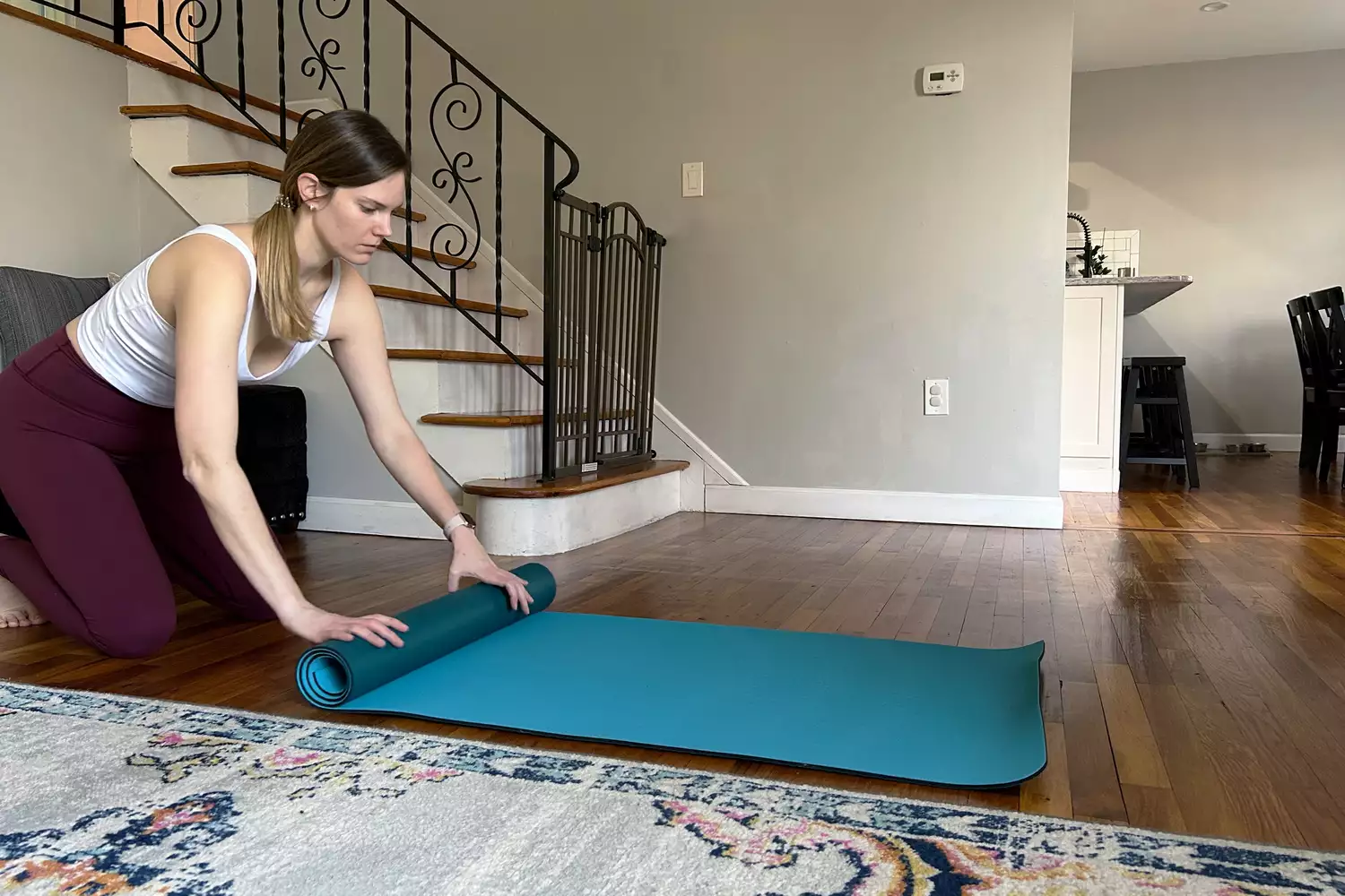 A person rolling up lululemon The Workout Mat 6mm