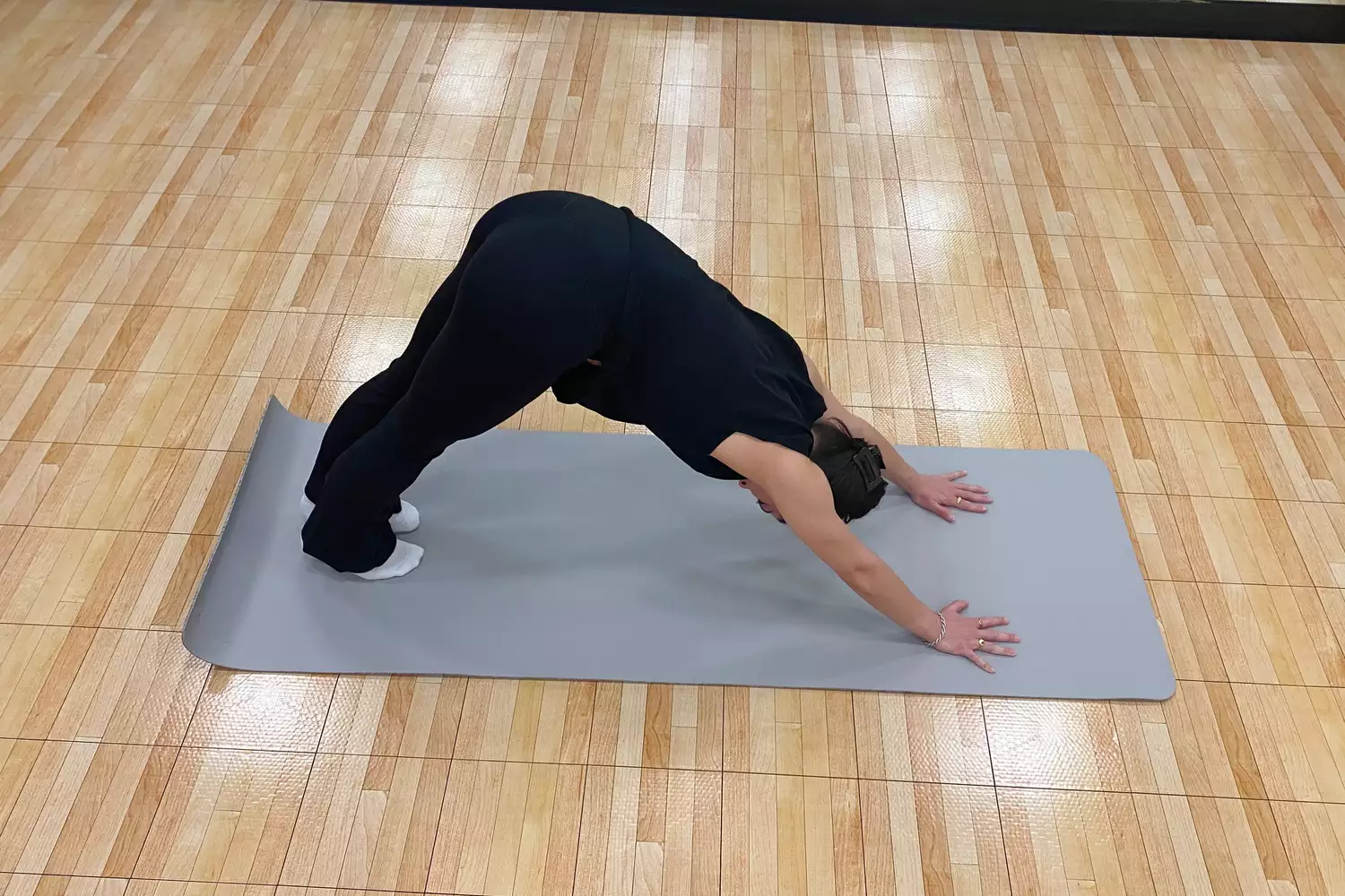 A person doing yoga on the Nike Mastery Yoga Mat