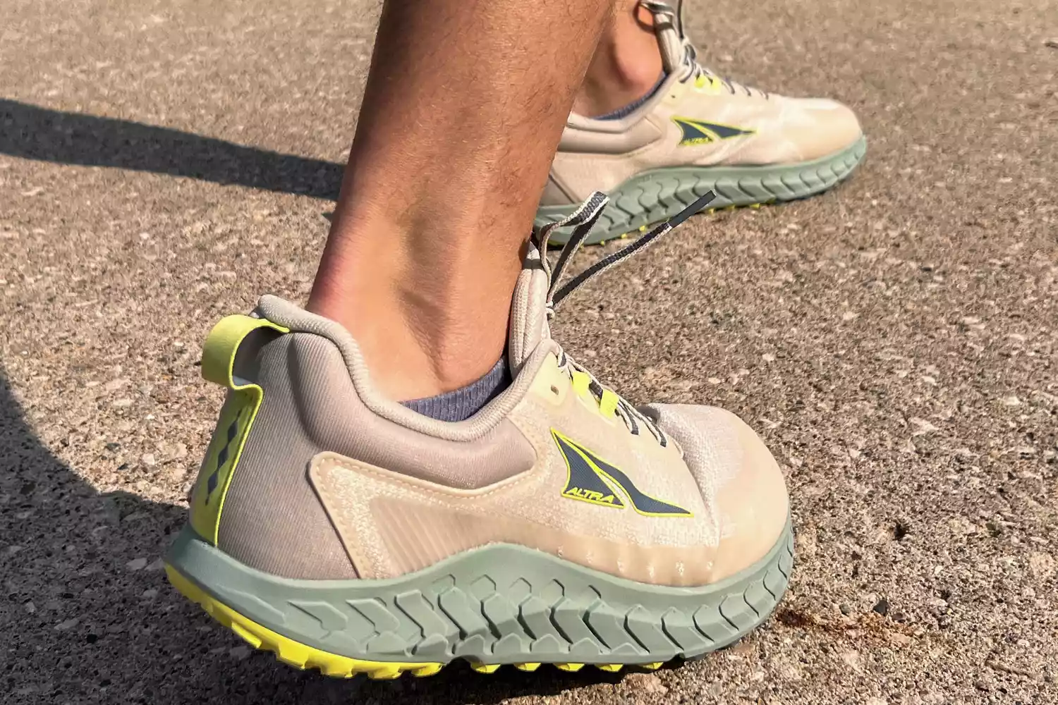 A close-up of two legs walking in Altra Outroad 2 sneakers