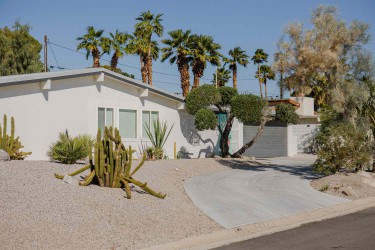 White ranch-styled house with drought-tolerant landscaping