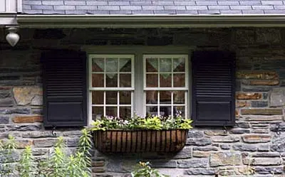 A window box with flowers planted in it.