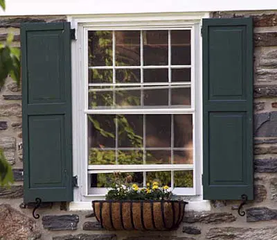 A window box with flowers planted in it.