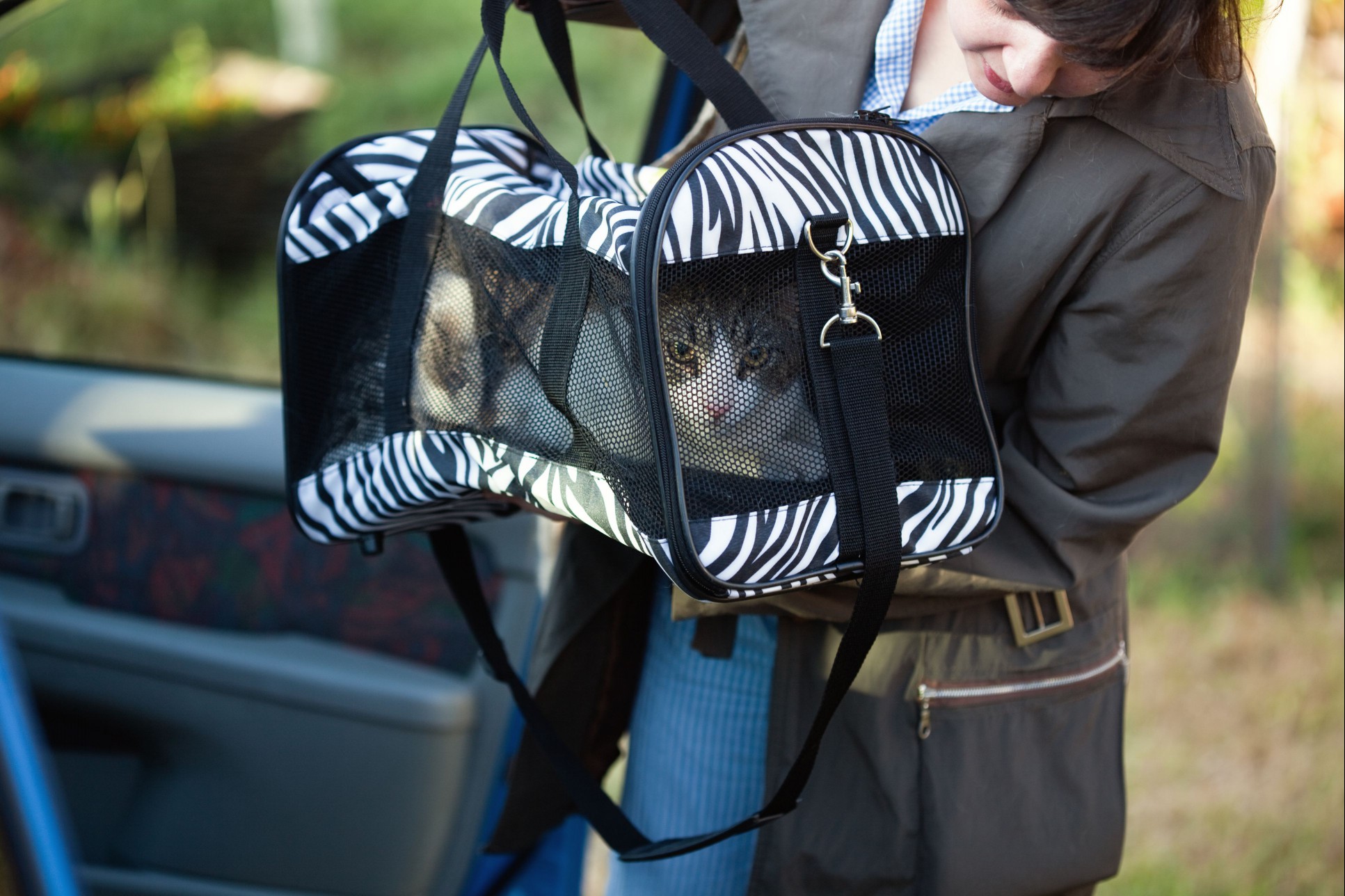 Woman with cat in pet carrier