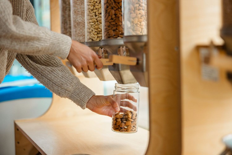 Woman filling jar of nuts