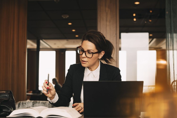 An accountant pores over an economics book. 