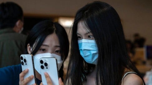 Shoppers look at two of the newly launched iPhone 15, on September 22, 2023 in Beijing, China.
