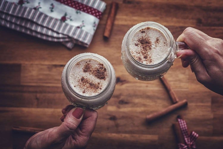 people holding glasses of eggnog