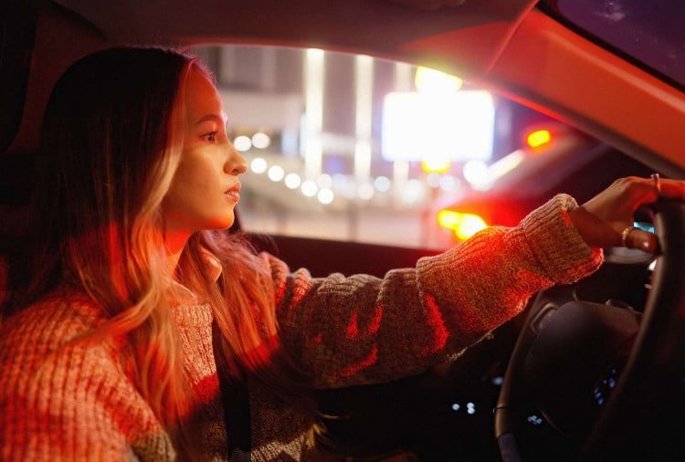 Woman driving at night
