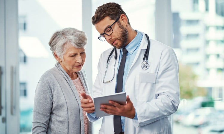 Doctor talking to an elderly female patient