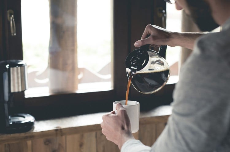 man pouring morning coffee